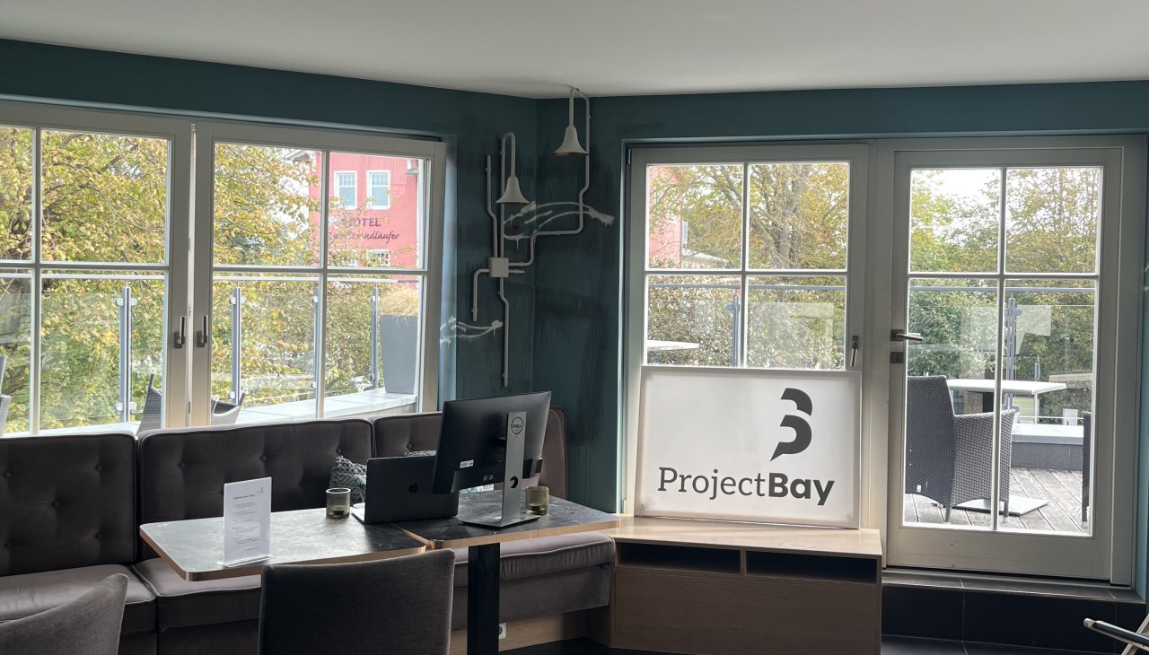 Cozy work area with large window front and modern design., © Michelle Dynio