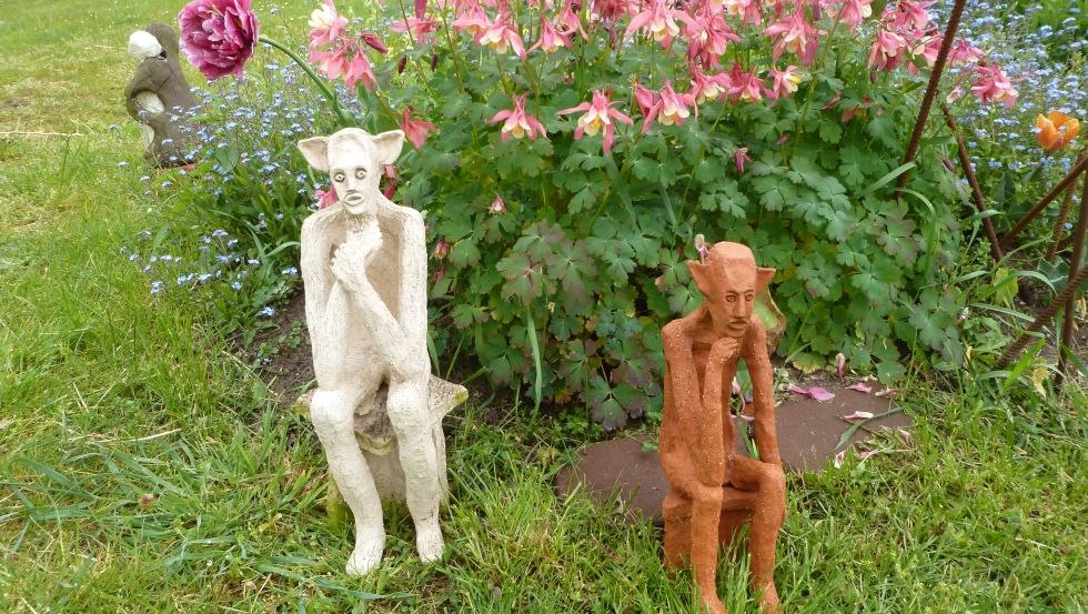 Mythische wezens van witte en rode klei verstoppen zich in de tuin., © Gerhard Güthoff