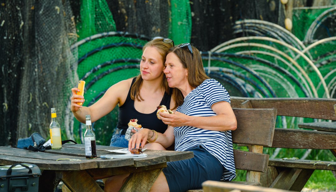 Mother and daughter take a selfie with a fish sandwich in Damerow