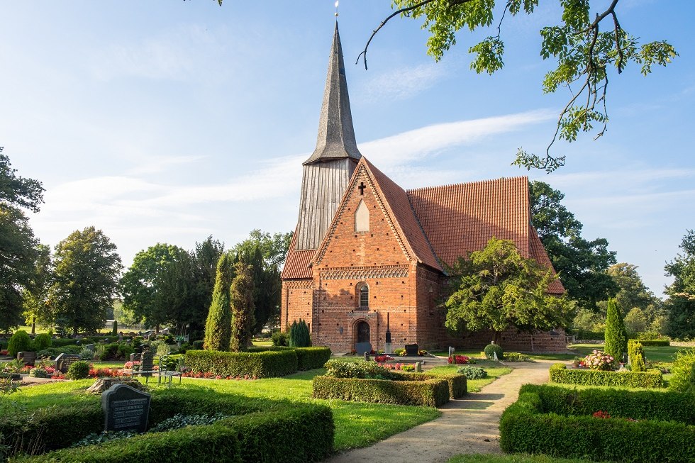 The village church is surrounded by a cemetery. // &copy; Frank Burger