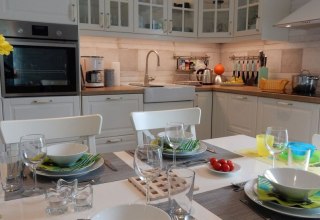 Tijd met het gezin in de moderne keuken met aangrenzende eethoek, © @cramer
