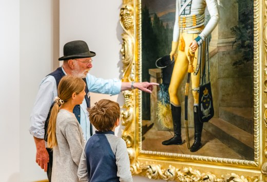 De rondleiding voor kinderen toont het schilderij van Prins Wilhelm Malte I en twee kinderen zijn verbaasd. // "Kijk eens naar het uniform! " De kinderen leren dat Prins Wilhelm Malte I Zweeds geel draagt. // © MV-T/Tiemann De rondleiding voor kinderen toont het schilderij van Prins Wilhelm Malte I en twee kinderen zijn verbaasd.