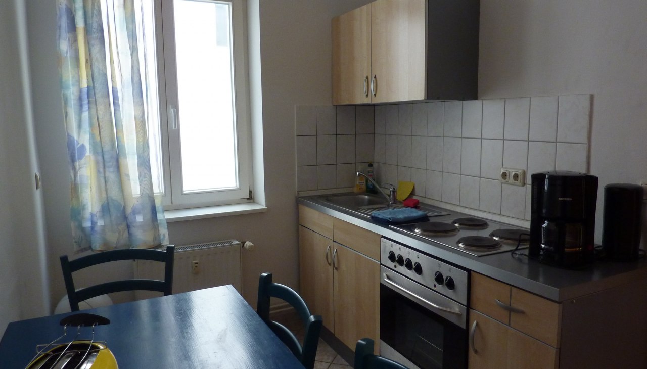 Kitchen with table and washing cabinet, © Galina Diran