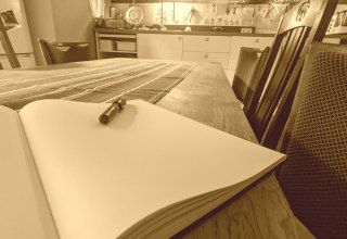 Blank page in a book, with pen on a kitchen table, © S. Pamperin