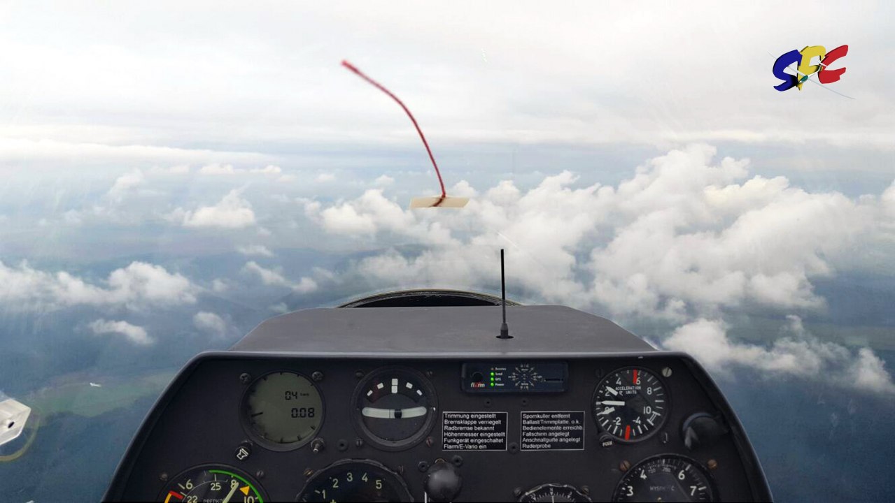 View over the cockpit of a glider. A loose cloud formation in the foreground. // © SFC Neustadt-Glewe View over the cockpit of a glider. A loose cloud formation in the foreground. // © SFC Neustadt-Glewe