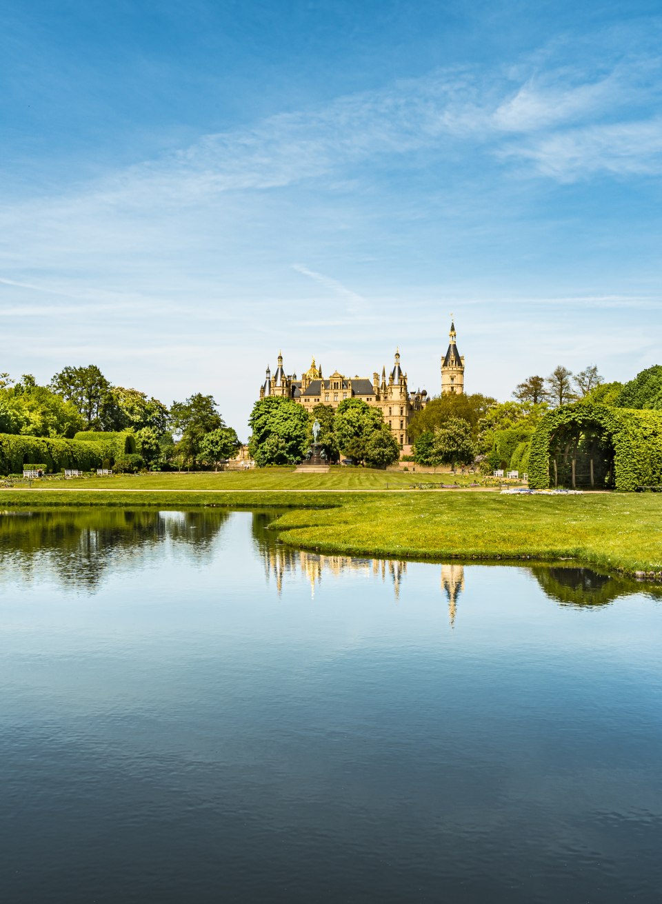 De paleistuin en het park in Schwerin aan de overkant van de tuinkanalen en uitzicht op het paleis. // Veel symmetrie: het gebied bij het paleis in de paleistuin van Schwerin is strikt barok van ontwerp. // © MV-T/Tiemann De paleistuin en het park in Schwerin aan de overkant van de tuinkanalen en uitzicht op het paleis.