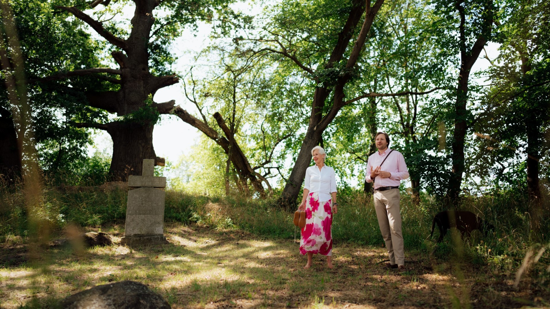Kerl und Jannis Achtenhagen steht unter großen Bäumen neben einem steinernen Kreuz am Grab in Ludorf. // Standing beneath old trees, Keril and Jannis Achtenhagen stand at the grave of Ludorf’s last lord and continue to tell the story. // © MV-T/Petermann Kerl und Jannis Achtenhagen steht unter großen Bäumen neben einem steinernen Kreuz am Grab in Ludorf. // Standing beneath old trees, Keril and Jannis Achtenhagen stand at the grave of Ludorf’s last lord and continue to tell the story. // © MV-T/Petermann