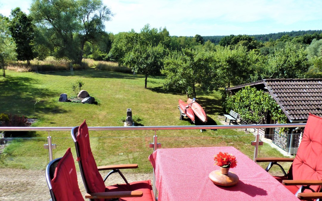 View from the balcony to the sunbathing lawn with campfire place, © Manfred Sohn