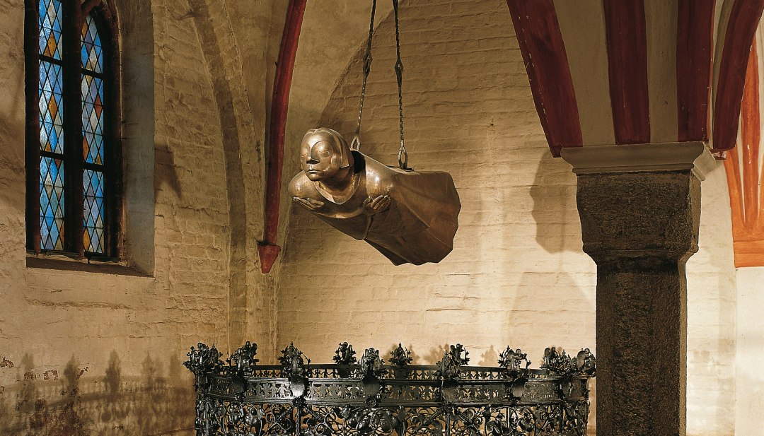 The Floating Man by Ernst Barlach exhibited in G&uuml;strow Cathedral. The sculpture hangs from the ceiling and thus floats at head height.