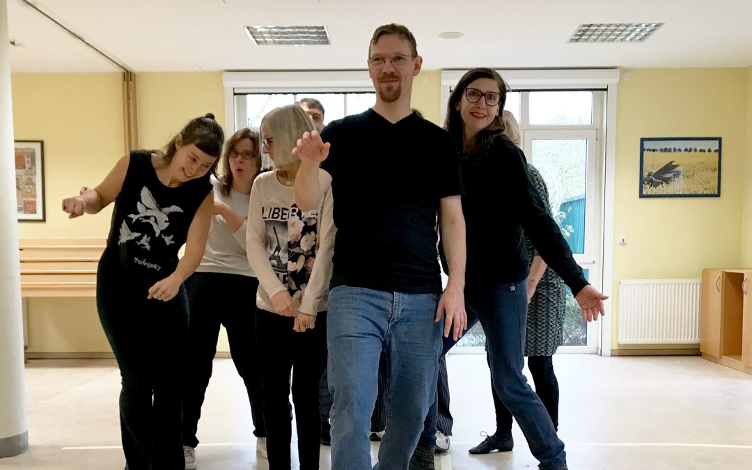 Een kleine groep mensen beweegt zich naar de camera in een seminarruimte, elke persoon in een andere houding., © Sarah Bansemer