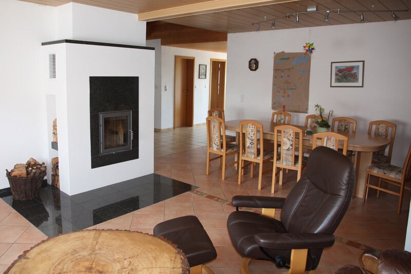 Interior view living & dining area with fireplace, © Mario Bünger
