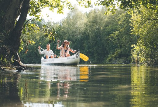 A canoe paddles along Lake Jamel in the sunshine