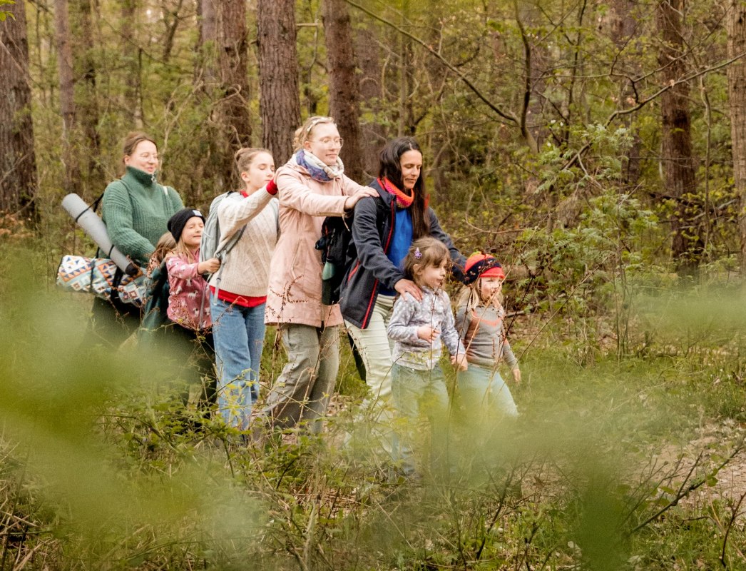 Children and adults are currently enjoying a forest bath. They walk mindfully through the forest with their eyes closed. // &copy; Christine D&ouml;rband / Langdock