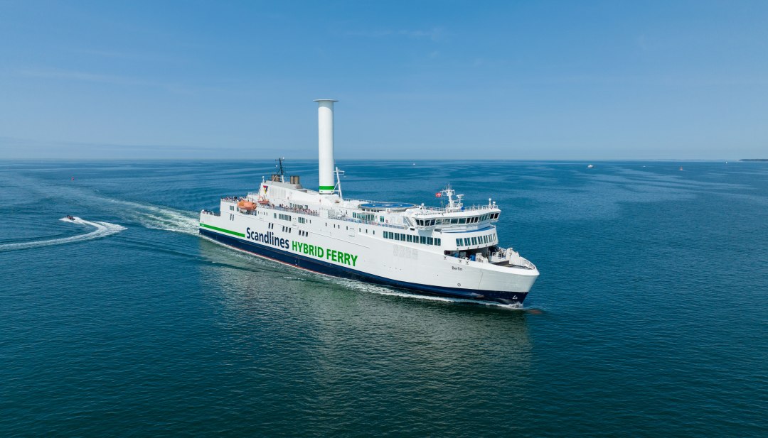 The Scandlines hybrid ferry "Berlin" is sailing across the Baltic Sea towards Denmark in sunny weather.