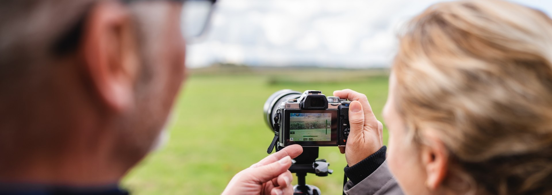 Twee mensen controleren een foto op de camera tijdens een workshop op Fischland-Darß-Zingst.