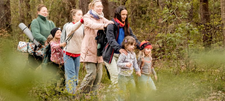 Children and adults are currently enjoying a forest bath. They walk mindfully through the forest with their eyes closed. // &copy; Christine D&ouml;rband / Langdock