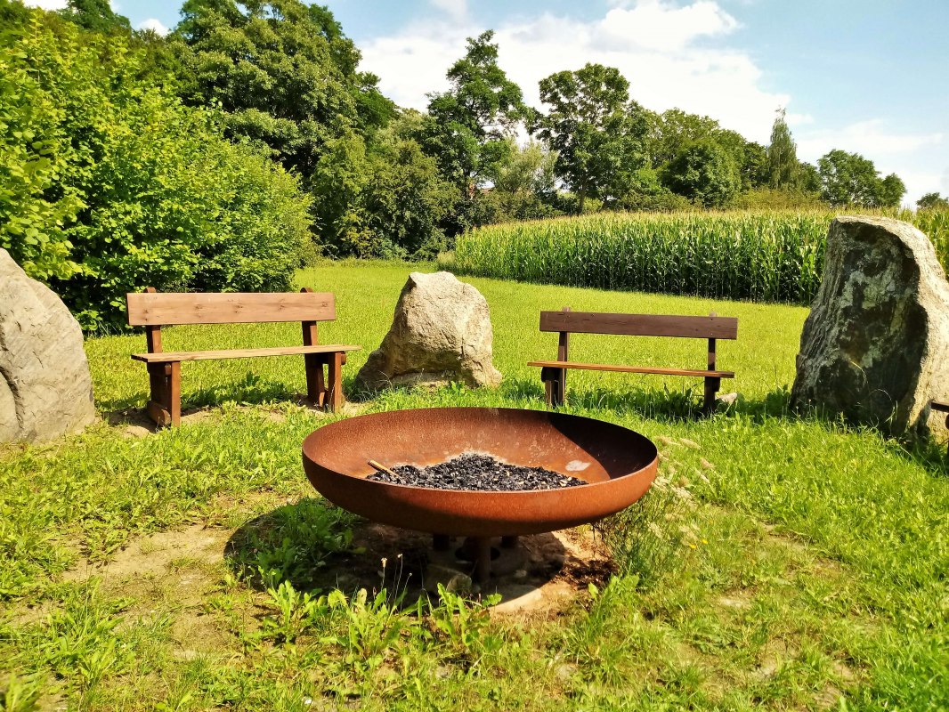 The fireplace in the boulder garden invites you to linger. Here you can make a small fire, grill sausages, or just sit comfortably together. // &copy; Wolfgang Mamat