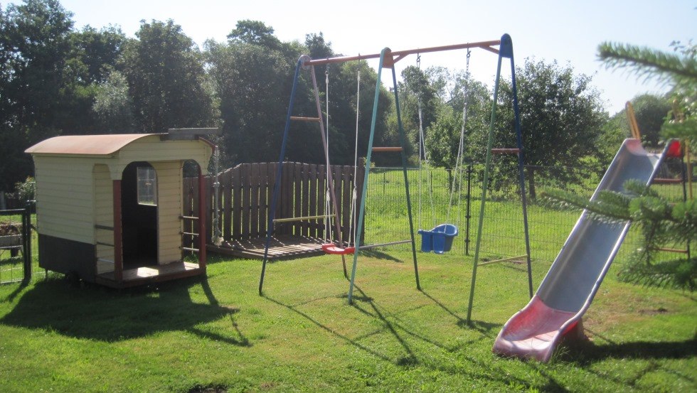 Playground with playhouse, sandbox, swing and slide // © Richter Playground with playhouse, sandbox, swing and slide // © Richter