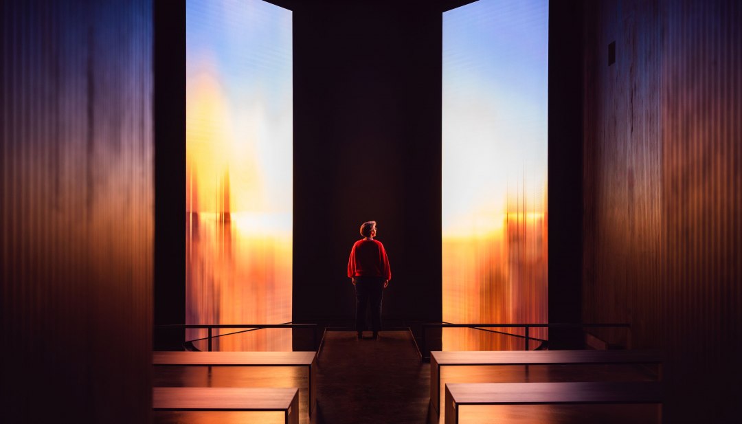 Birte Frenssen, curator and deputy director of the Pomeranian State Museum, in front of an illuminated art installation.