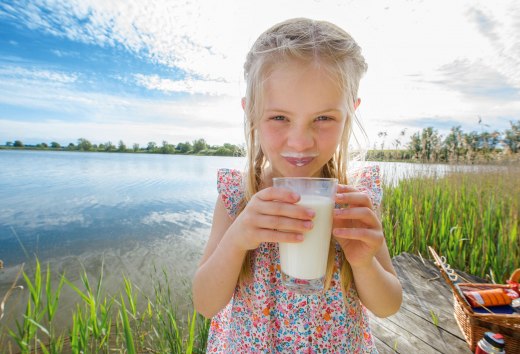 Girl drinking a freshly tapped glass of milk, &copy; TMV/outdoor-visions.com