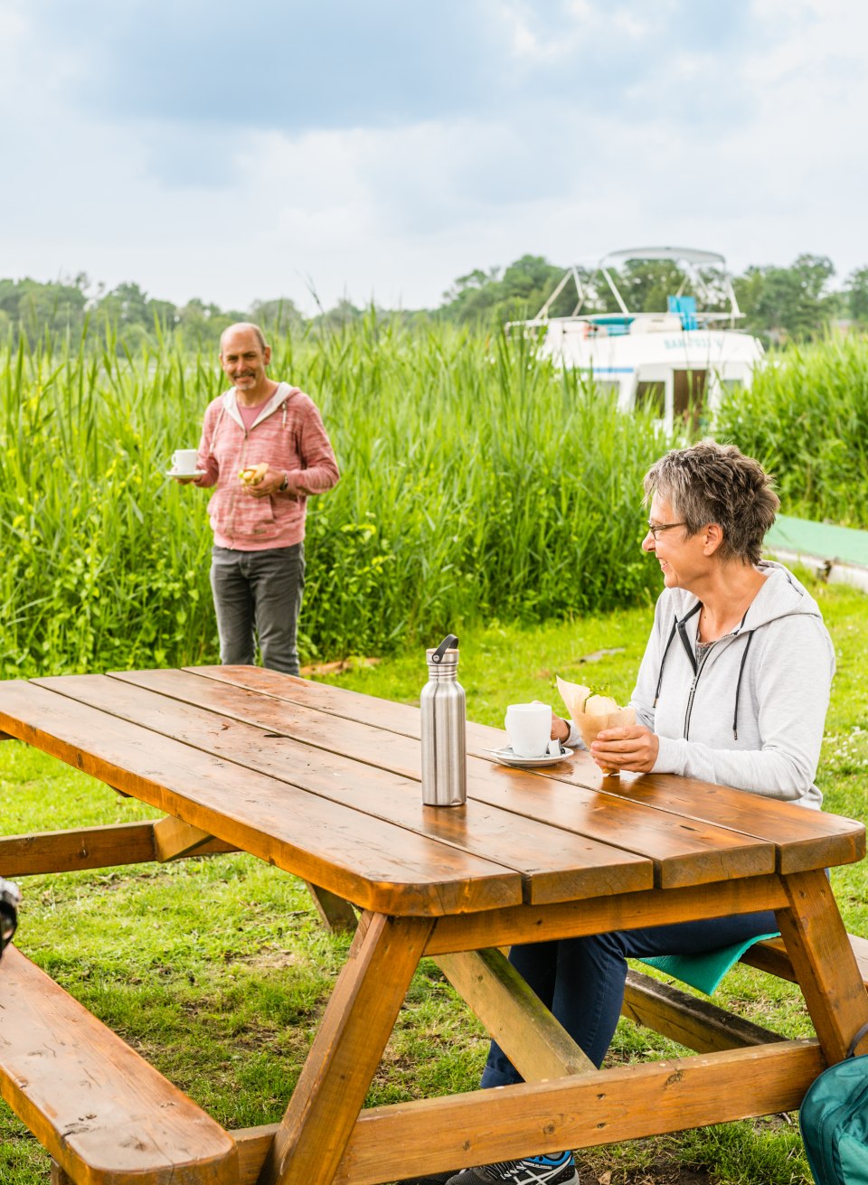 A couple eating fish sandwiches at the snack bar next to the Ahrensberg house bridge