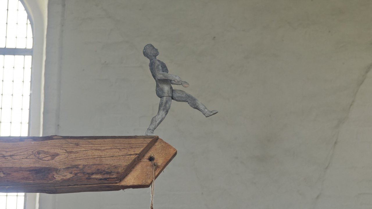 Figure walks across beams in an empty church interior // © Christian Böhler Figure walks across beams in an empty church interior // © Christian Böhler